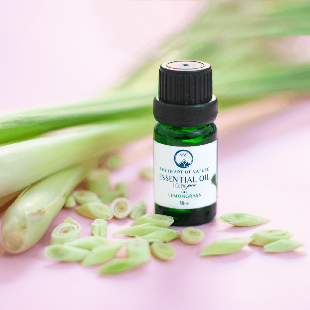 Lemongrass essential oil bottle with fresh stalks on pastel background, perfect for aromatherapy.